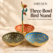 Complete decorative bird stand with three scalloped bowls in blue, dark green and red.