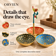 Floral decoration, scalloped bowl edges and ornamental bird feature on the three-bowl stand.