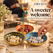 Three-bowl bird stand holding individually wrapped sweets in a hosting scene.