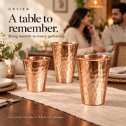 Three hammered copper glasses in a table setting; one pack includes 4, 5 and 6 inch glasses.
